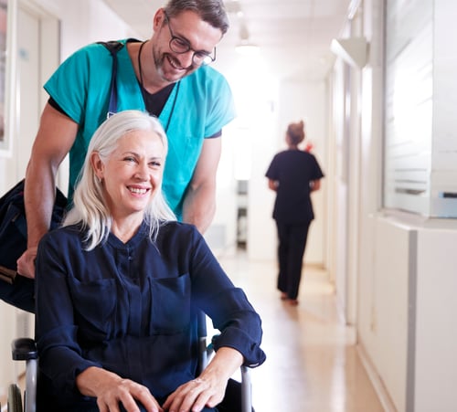 nurse pushing a patient on a wheelchair