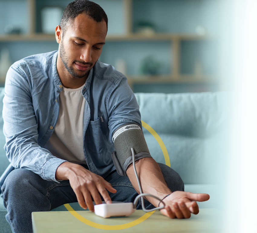 Man in his 30s is turning on a blood pressure device