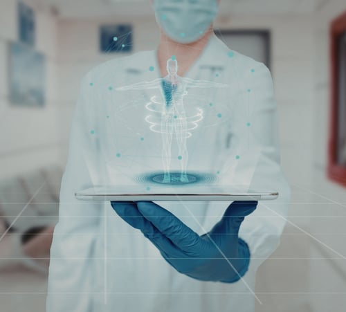 Doctor is holding a tablet that has digital representation of a human body