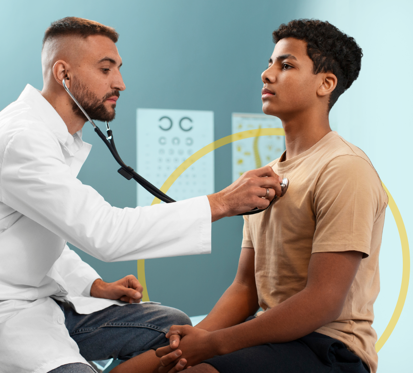 Male doctor checking a young man's heart with a stethoscope
