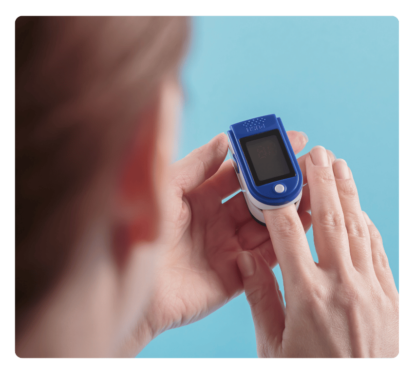 Woman using a fingertip pulse oximeter