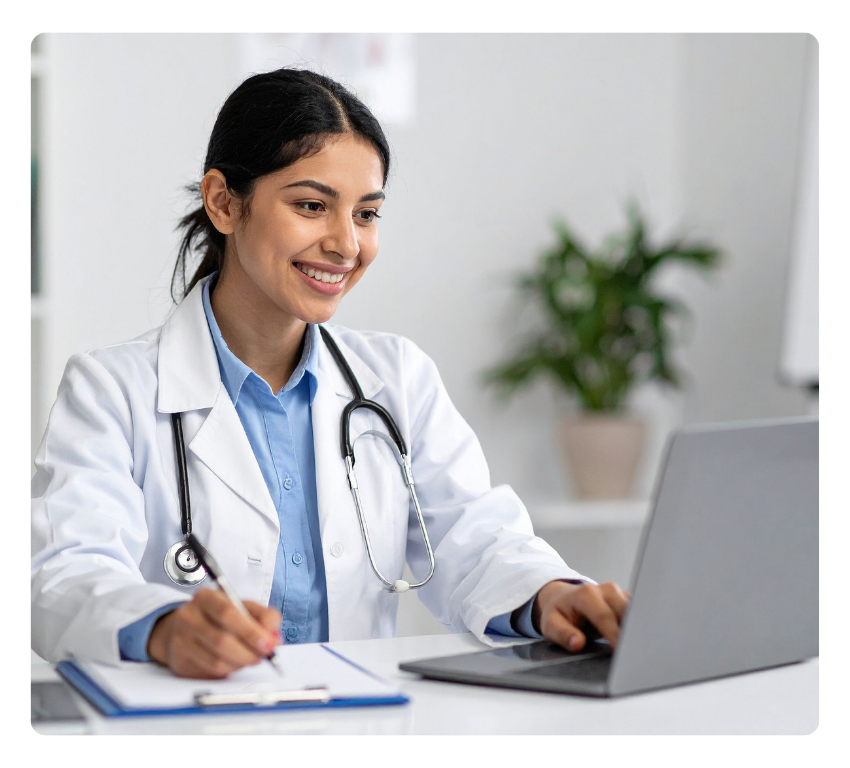 Smiling female doctor looking at a laptop